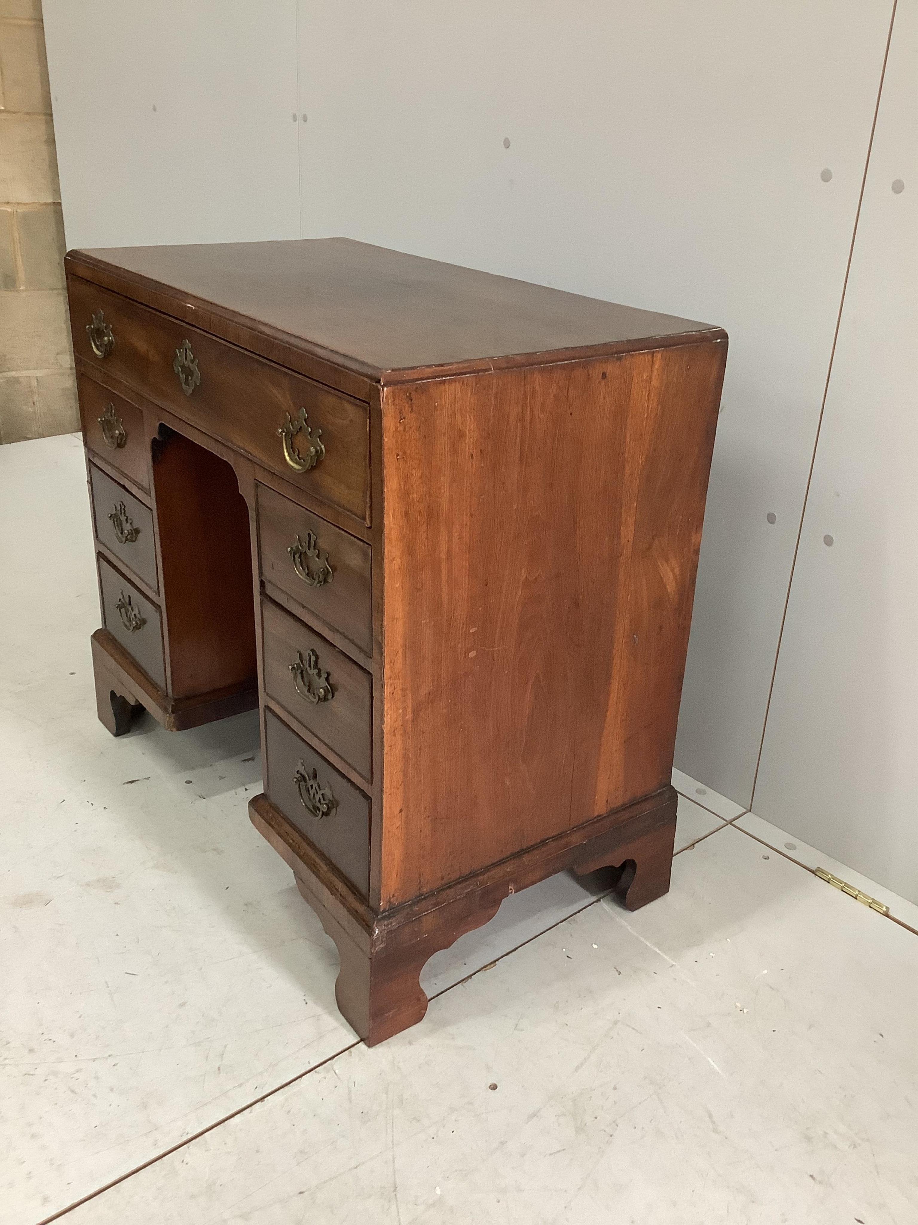 A George III mahogany kneehole desk, width 83cm, depth 44cm, height 76cm. Condition - fair